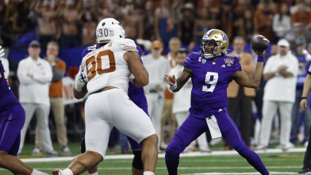 Jan 1, 2024; New Orleans, LA, USA; Washington Huskies quarterback Michael Penix Jr. (9) passes the ball as Texas Longhorns defensive lineman Byron Murphy II (90) chases in the 2024 Sugar Bowl college football playoff semifinal game at Caesars Superdome. Mandatory Credit: Geoff Burke-USA TODAY Sports  